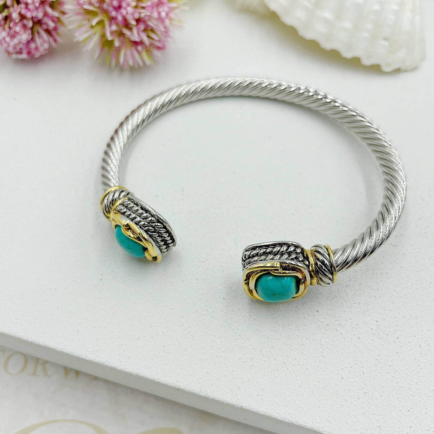 Open Twisted Arch With Stones At The Ends With Gold Accents Bracelet