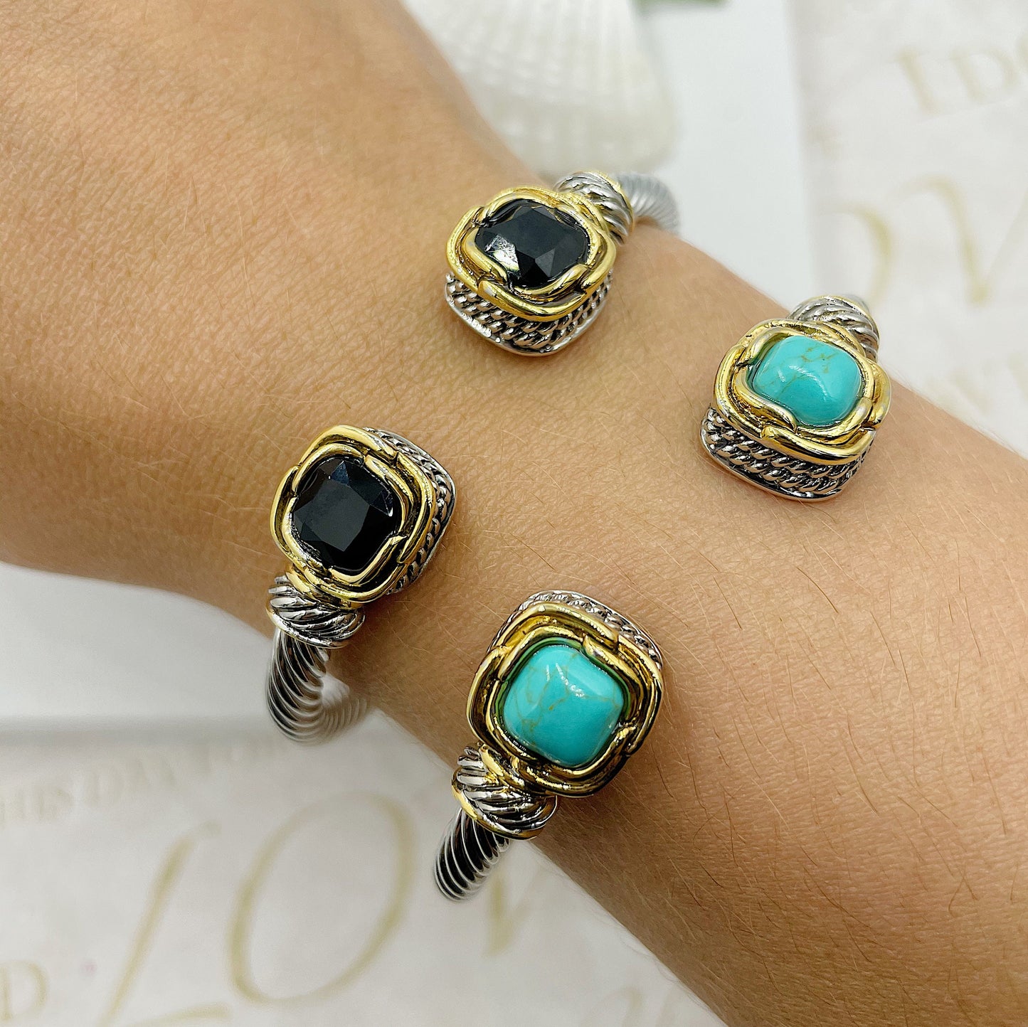 Open Twisted Arch With Stones At The Ends With Gold Accents Bracelet