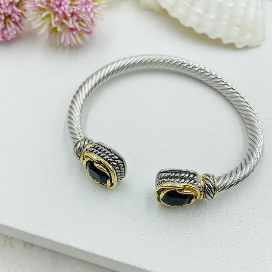 Open Twisted Arch With Stones At The Ends With Gold Accents Bracelet